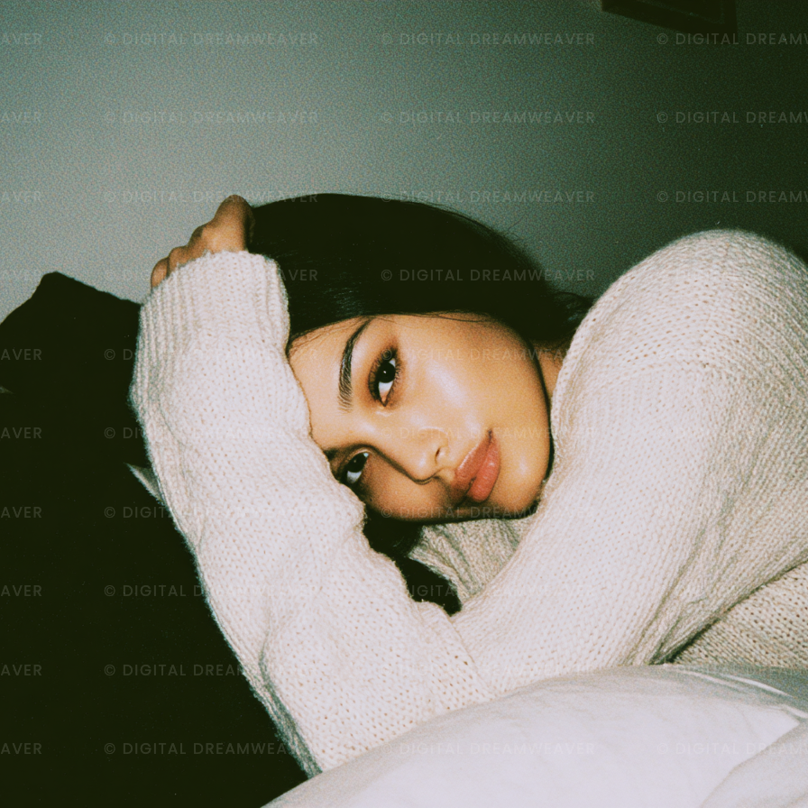 Person wrapped in a blanket with a dark background