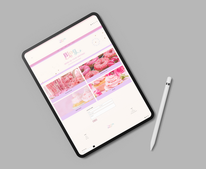 Tablet displaying a floral website on a gray background with a stylus pen beside it